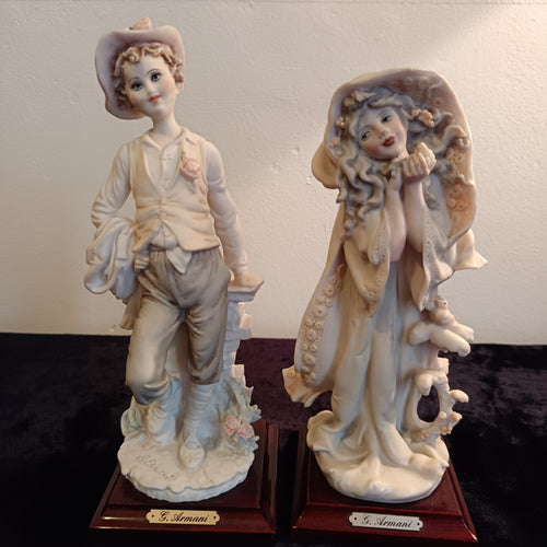 A pair of Capademonte figurines Winter & The country boy by G Armani