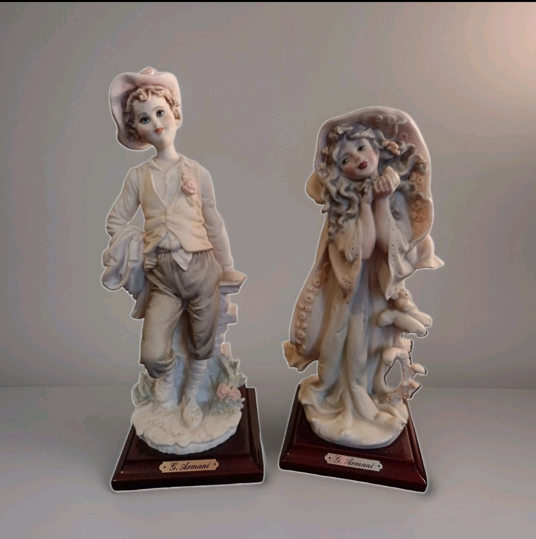 A pair of Capademonte figurines Winter & The country boy by G Armani